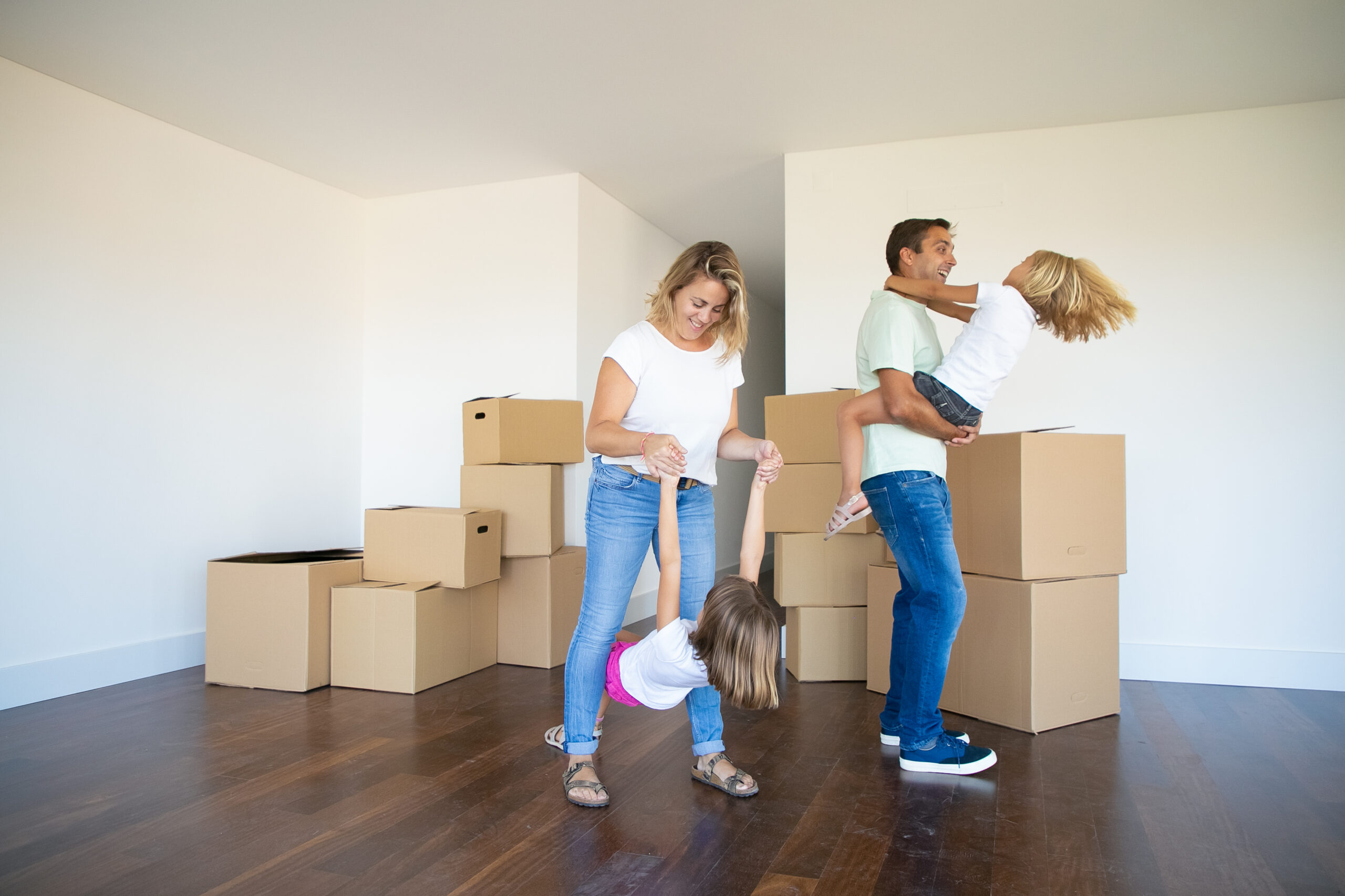 Joyful parents and kids enjoying new home