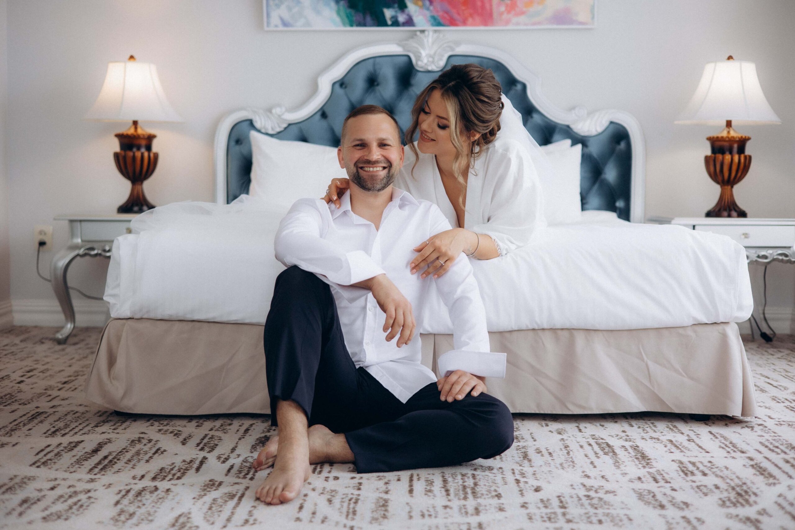 man-woman-pose-bed-hotel-room